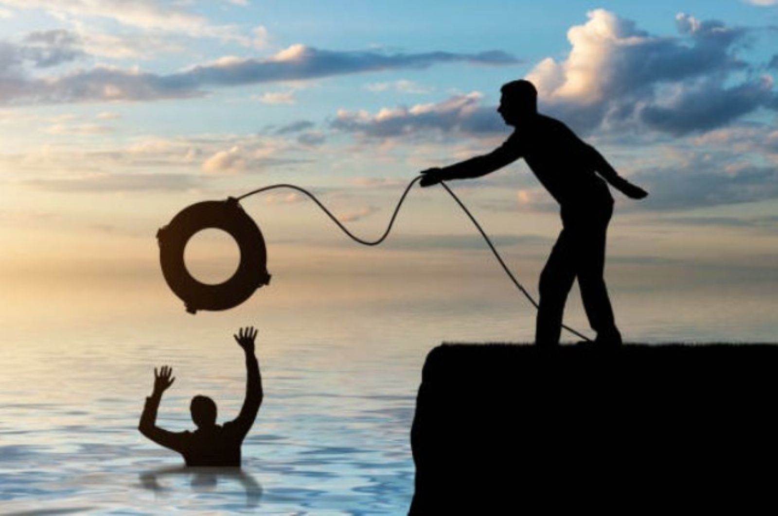 Man on rock outcropping throwing a drowning man a life preserver