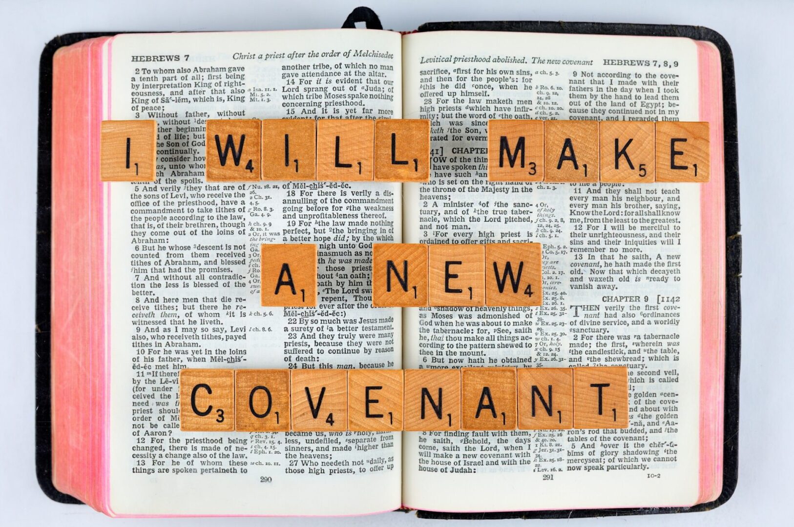 A word is spelled out on top of an open bible.