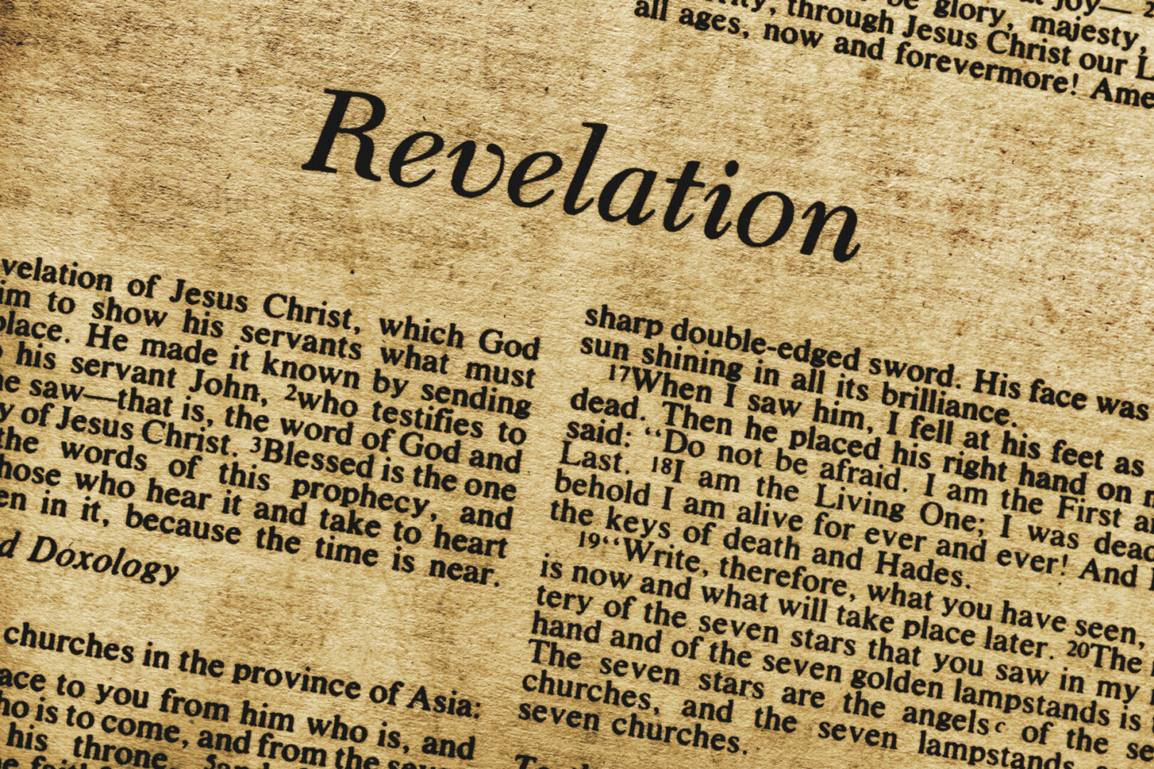 A close up of the word revelation on top of an old newspaper.