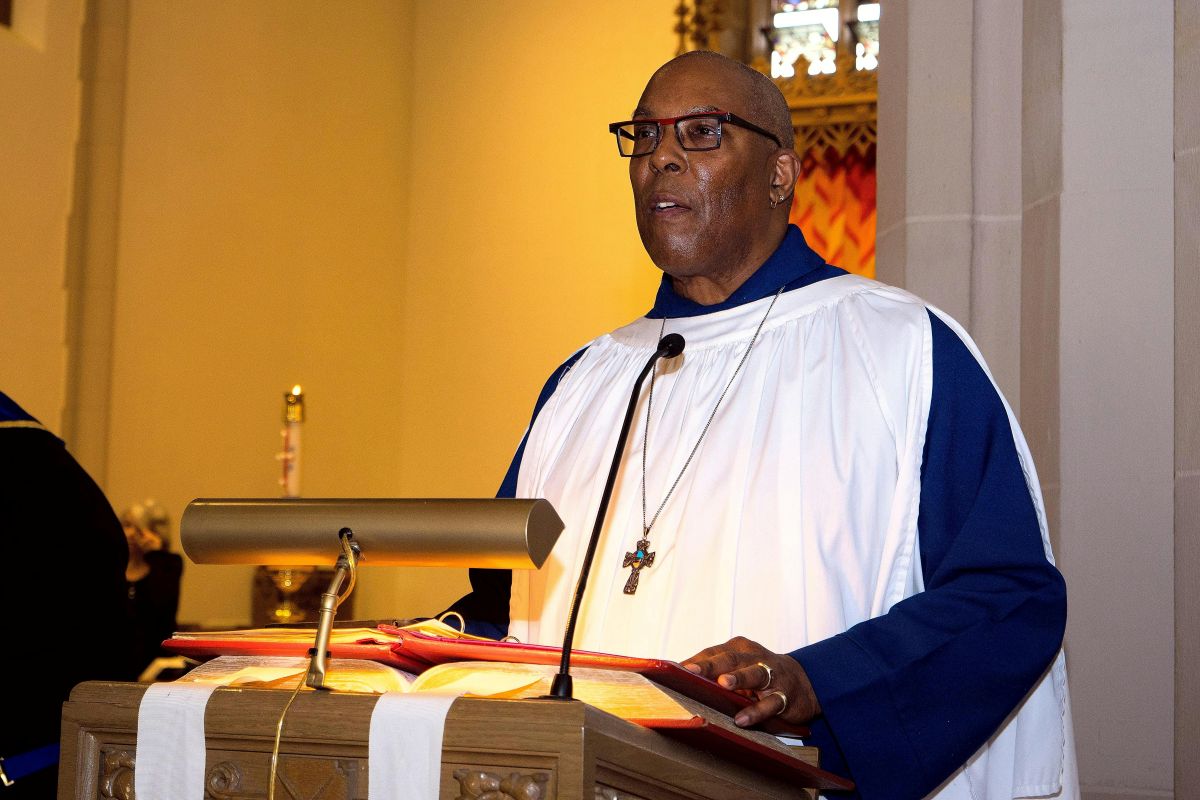 Man in robe preaching at a pulpit