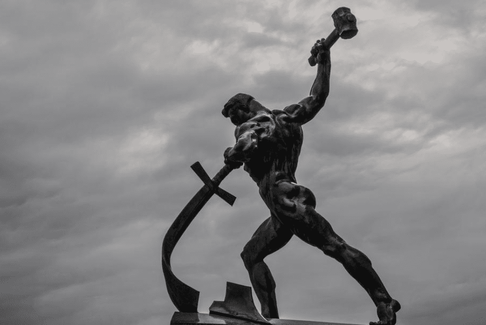 A statue of a man holding a sword and a cross.