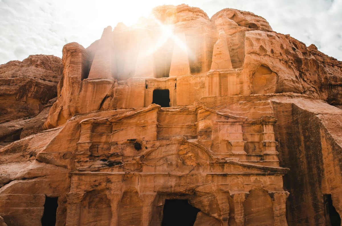 Hillside tomb with bright light shining out of one of the rock windows