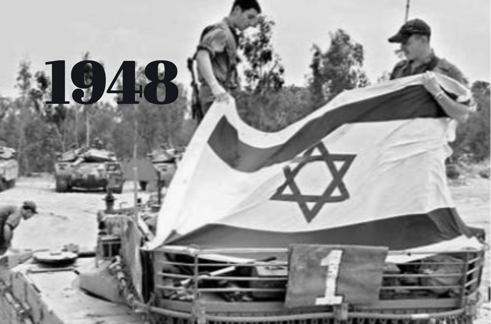 Israeli soldiers standing on tank holding up Israeli flag