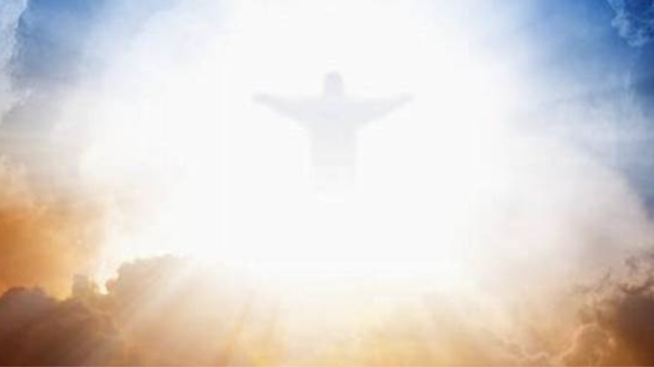 Jesus Will Not Return Until the Jews Accept Him as Messiah.docx Feint outline of Jesus with his arms spread, appearing amongst blue and red clouds.