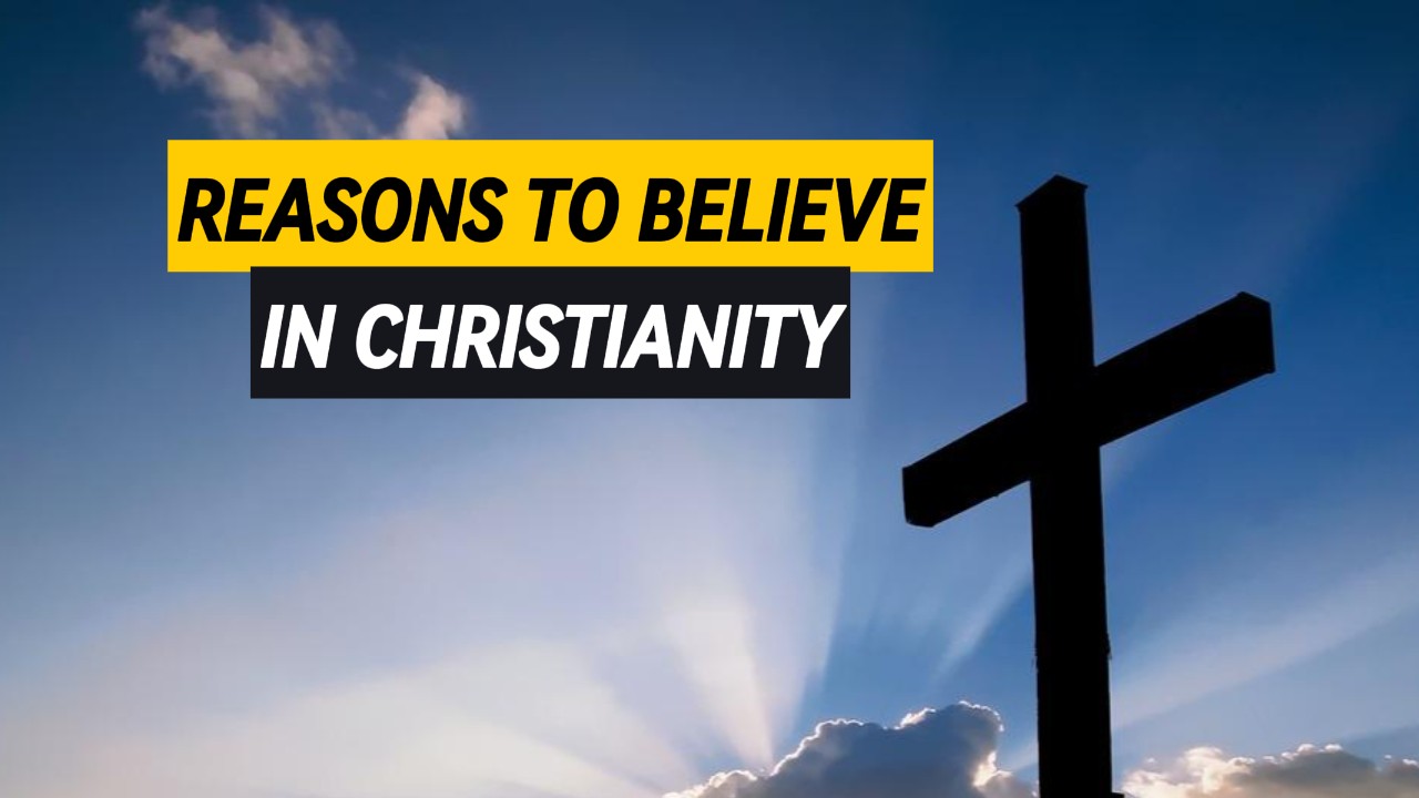 A cross with clouds in the background and rays of sunlight piercing through.