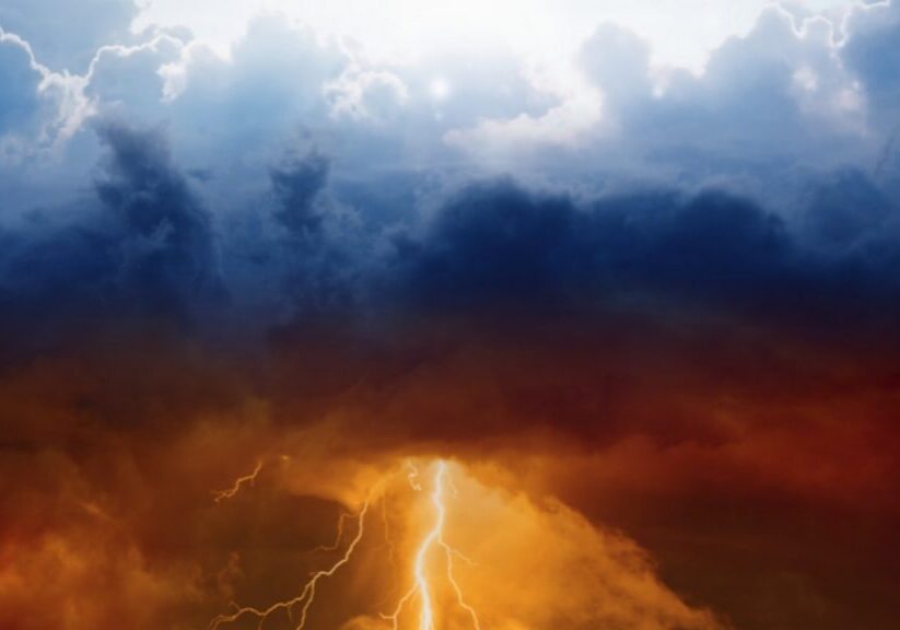 Depiction of blue sunny clouds above and red lightning clouds below