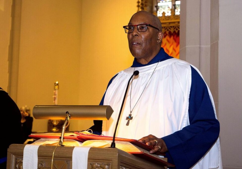 Man in robe preaching at a pulpit