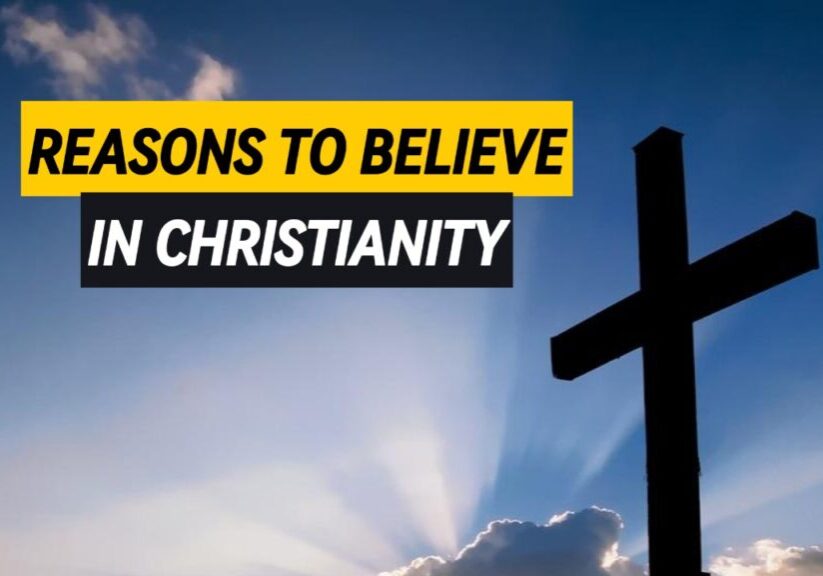 Reasons to Believe in Christianity A cross with clouds in the background and rays of sunlight piercing through.