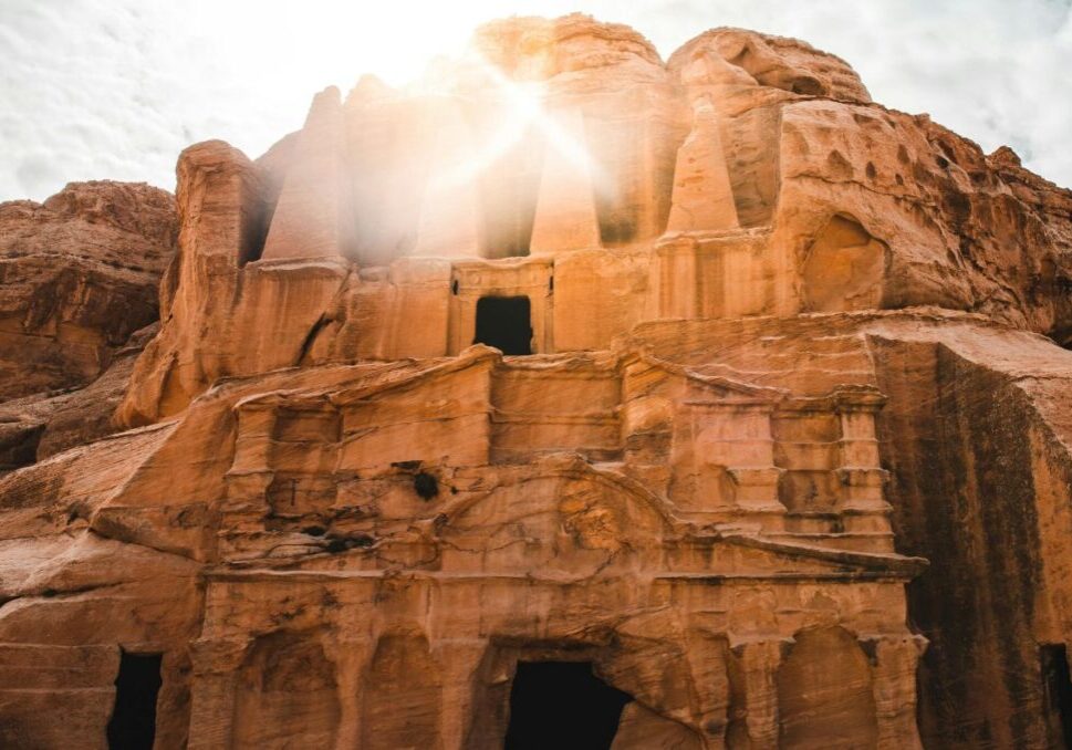 Hillside tomb with bright light shining out of one of the rock windows